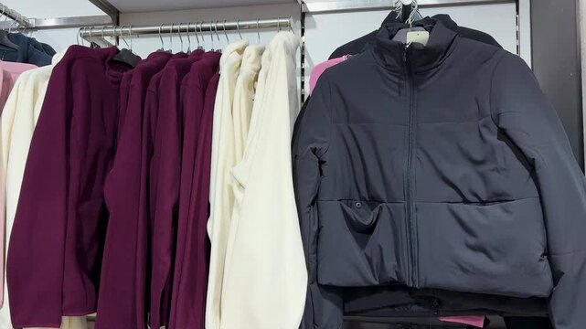 cozy pullovers displayed on garment rail within modern clothing boutique