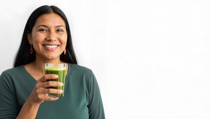 Smiling indigenous woman holding glass of green juice for healthy lifestyle and nutrition. Cheerful person embracing wellness with vibrant drink promoting vitality. Concept of healthy living.