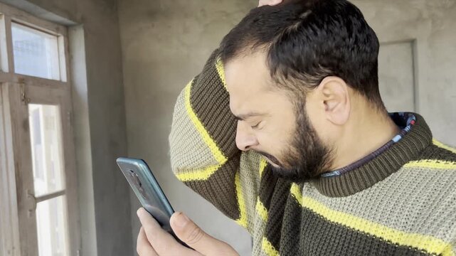 Man receive fraud message or scam message gets annoyed angry and frustrated. Man showing angry or annoyed after seeing fraud message from scammers using harsh words. Man gets scammed or cheated.