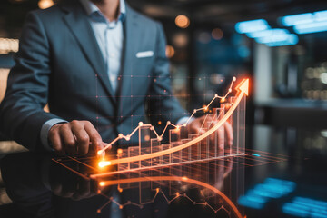 Businessman in formal suit interacting with glowing financial graph showing growth and success on modern dark table