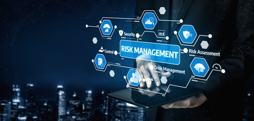 A business professional is using a digital tablet, presenting various risk management concepts such as security and crisis management against a modern cityscape backdrop. Tessel