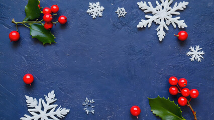 Christmas Holly Berries and Snowflakes on Dark Blue Textured Background for Festive Design