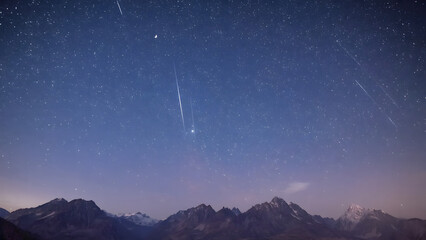 Meteor Shower Streaks Across Starry Night Sky Over Mountain Range
