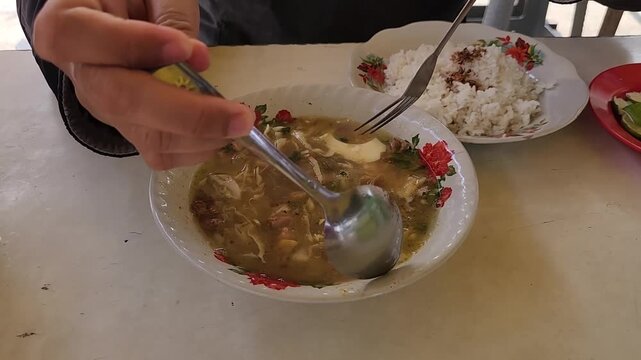 Savor the taste of Soto with rice, a traditional Indonesian dish. Soto served with rice and savory koya for a satisfying meal. Indulge in authentic Soto soup, topped with koya and accompanied by rice