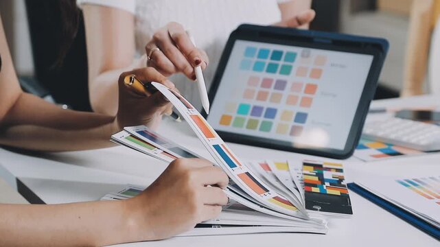 Young tailor working with textile in atelier
