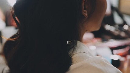 Positive professional hairdresser working on the salon