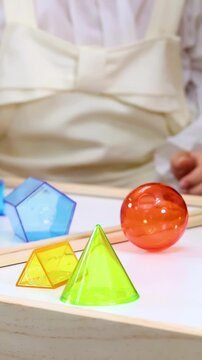 Child Learning Geometry With Colorful Transparent Blocks