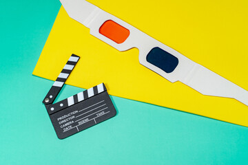 A cine themed still life with 3D glasses and a clapperboard set against vibrant backgrounds. This composition evokes the magic of cinema.
