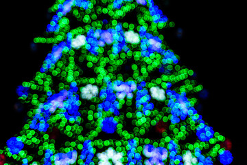 Background of the blurred colorful christmas lights. Bokeh pattern