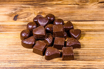 Heap of chocolate candies on a wooden table