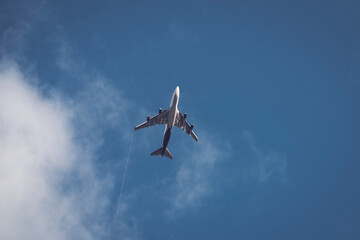 Airplane Flying Overhead Against Clear Blue Sky