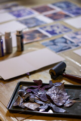 Botanical monoprints drying on table during handmade card sessio