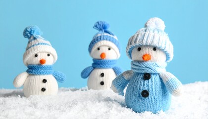 little knitted snowmans on soft snow on blue background 343671.jpg