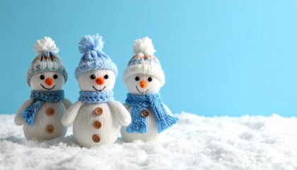 little knitted snowmans on soft snow on blue background 343671.jpg