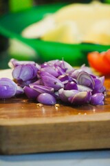 Freshly Chopped Red Onions on a Wooden Cutting Board Ready for Cooking.