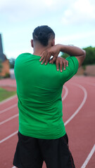 Fototapeta premium Rear view shot of a man suffering from a shoulder pain