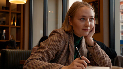 Portrait of a smiling young woman in a relaxed learning or work environment
