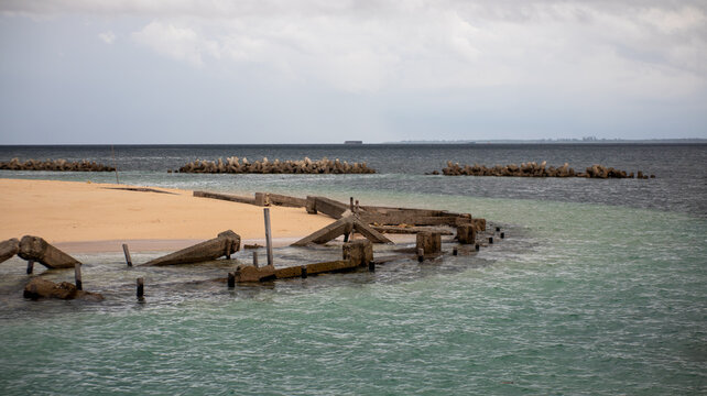 Ruins of Coastal Breakwater Structure in Calm Ocean Water at Beras Basah