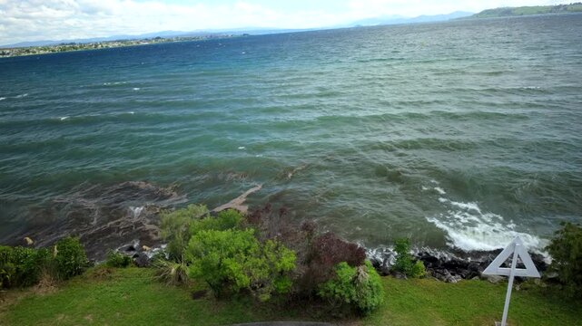 Windy Lake Shore With Road Sign