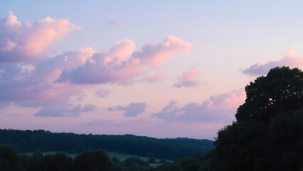 Pink and purple clouds over a green landscape at dusk pink clouds purple sky