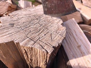 Chopped Firewood and Axe in Sunlight