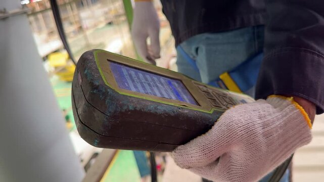 Hand of officer is holding gas analyzer reading oxygen and gas levels, ideal for safety inspection and industrial operations.