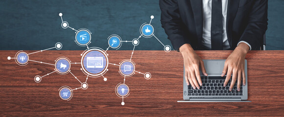 A modern businessman types on a laptop at a stylish wooden desk, surrounded by digital icons representing technology and connectivity in a corporate environment. Tessel