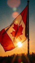 Silhouette of a Canadian flag against a sunset, great for artistic projects or cultural representations.