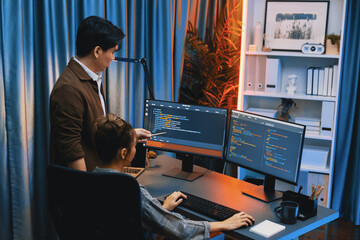 Smart IT developer looking at coding program application on computer screen of online website at...