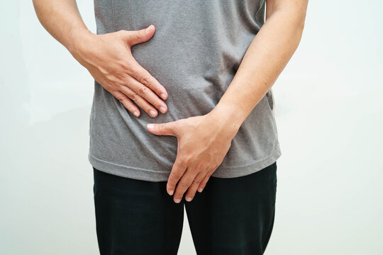 Hernia, Asian man stomach ache, abdominal pain and urology problem health.