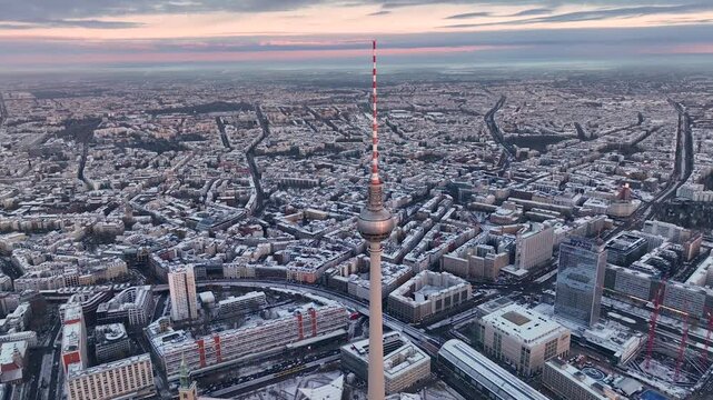 City of Berlin, Germany from above. Aerial winter cityscape view at sunrise or sunset, showing architectural landmarks Oberbaum Bridge, TV Tower and Berlin Cathedral in winter. 