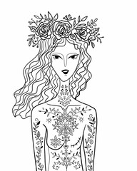 Woman with long hair and flowers on head stands with floral tattoos