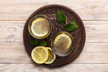 Healthy breakfast or morning with chia seeds lemon and mint on table background, vegetarian food, diet and health concept. Chia pudding with lemon and mint