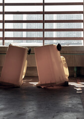 View of After cleaning big plastic yellow garbage container and turn upside down to dry. Yellow large plastic rubbish bin near concrete wall on parking lot of condominium building, Copy space, selecti