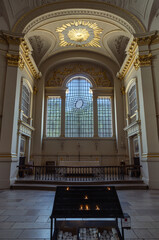 Architecture interior with arched ceilings, Corinthian columns and glass is subtly distorted within a lattice of curvilinear glazing bars is the east window. which blend elements of Baroque ornamentat