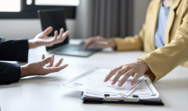Business people hold a resume and talk to job applicants for job interviews about careers and Their personal history in the company. Recruitment concepts