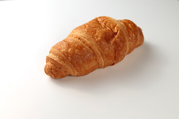 Crispy hot croissant on a white background. Insulation