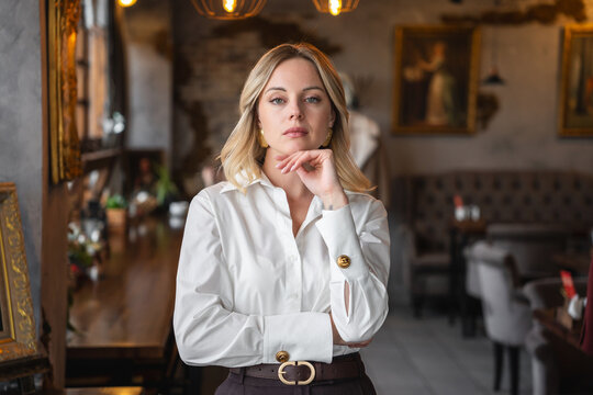 Woman with hand to chin. Elegant, thoughtful.