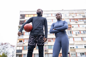 Female and male friends ready for a basketball game.