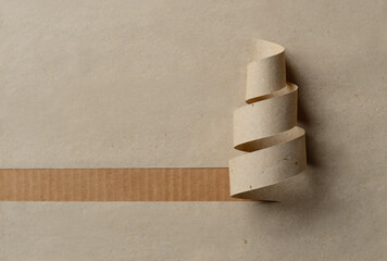 Minimalist Christmas tree made of paper spiral on craft background