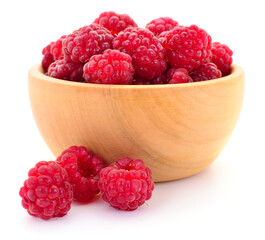 Fresh red raspberries in wooden bowl isolated on white background