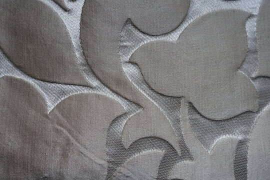Top view of beige and silver single damask jacquard fabric