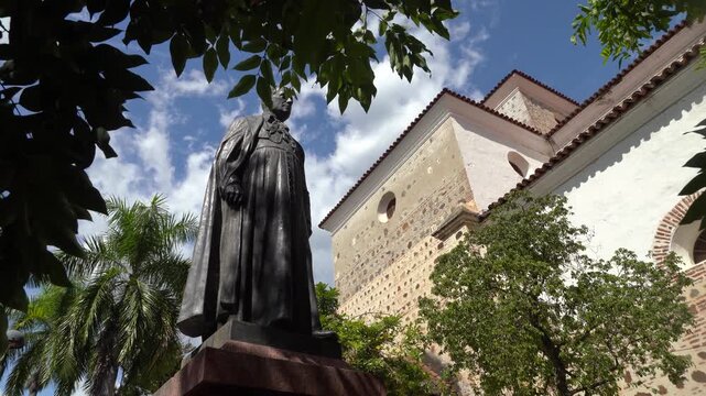 Stationary shot of the Monument to Marshal Jorge Robledo in front of the historic Metropolitan Cathedral Basilica of Santa Fe de Antioquia, Colombia