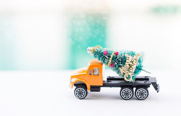 Christmas tree on orange truck with space over blurred background, Christmas tree shopping and shipping
