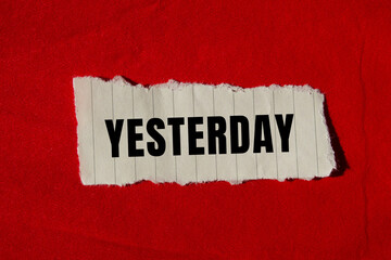 Yesterday message written on ripped torn paper background. Conceptual Yesterday symbol. Copy space.