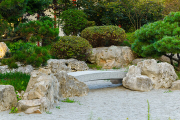 rock stone garden floral outdoor environment space Mediterranean aesthetic region of south Europe with summer green plants and bushes near small decorative trees and small concrete bridge view