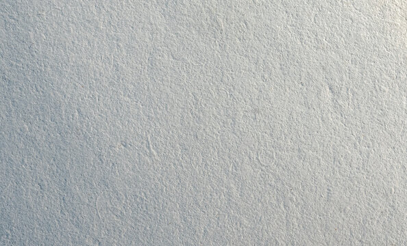 Seamless recycled paper pattern with subtle speckle and fiber effect in white and soft gray. Organic grain texture perfect for eco design, packaging, stationery, or backgrounds. Drag to swatches