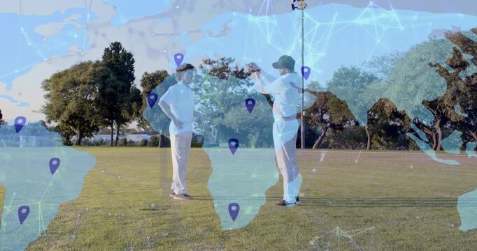 Two men reaching on field, starting animated tech map overlay with pins, passing device for demo