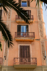 Traditional Balcony and Ornate Railing on a Mediterranean Residential Building with Palm Fronds, Palma