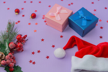 Gift boxes with ribbons, Santa hat and Christmas decoration
